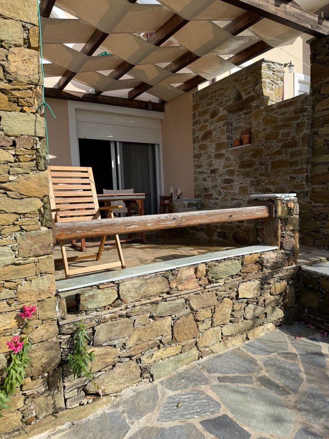 Stone patio with wooden furniture